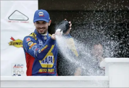  ?? MATT SLOCUM — THE ASSOCIATED PRESS ?? Alexander Rossi celebrates in Victory Lane after winning the IndyCar auto race at Pocono Raceway, Sunday in Long Pond, Pa.