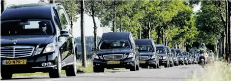  ?? Sander KONING/AFP/Get ty Images ?? Hearses carry coffins holding the remains of victims of the downed Malaysia Airlines jet near the Dutch city of Hilversum.