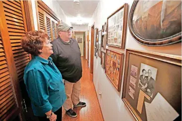  ?? [PHOTO BY STEVE GOOCH, THE OKLAHOMAN] ?? The Oklahoman’s reporter Matt Patterson looks at historical family documents Aug. 22 with his cousin, Joyce Gentry, in Ada. Patterson connected with her after taking a DNA test on Ancestry.com.