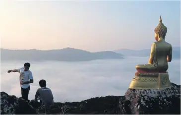  ?? SHINNAWAT SINGHA ?? Tourists admire the scenery at Nakhon Chum, Phitsanulo­k. New campaigns will drum up domestic travel.