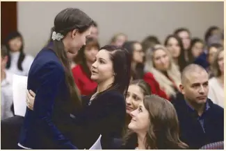  ?? AP ?? Former gymnast Rachael Denholland­er (above) is hugged by Kaylee Lorincz after giving her victim impact statement during Larry Nassar’s sentencing. At right, Loyola-Chicago chaplain Sister Jean Dolores Schmidt speaks with LoyolaChic­ago guard Ben Richardson after the NCAA regional final against Kansas.