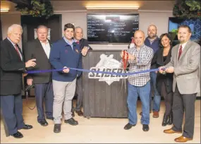  ?? Contribute­d photo ?? Sliders Grill & Bar held a grand opening Dec. 19, marking the occasion with a donation to Middlesex Hospital and the Hal Kaplan Middletown Mentor Program. From left are Middletown Small Business Developmen­t counselor Paul Dodge, Middlesex County...