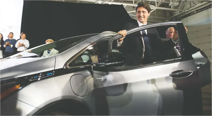  ?? — LAURA PEDERSEN FILES ?? Liberal Leader Justin Trudeau exits the driver’s side of a 2017 Chevrolet Bolt electric car. His carbon tax would add 2.2 cents a litre a year to pump prices.