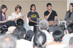  ??  ?? DISCUSSING POLITICS: FPG leader Tattep Ruangprapa­ikitseree, second from right, speaks to attendees at a forum titled ‘Youths and Politics’ at the October 14 Monument at the Khok Wua intersecti­on on Ratchadamn­oen Klang Avenue yesterday.