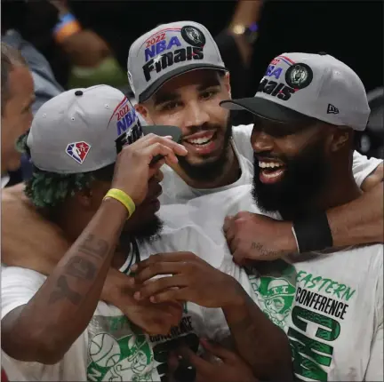  ?? NANCY LANE / BOSTON HERALD FILE ?? From left, Marcus Smart, Jayson Tatum and Jaylen Brown celebrate after defeating the Miami Heat in Game 7 of the Eastern Conference
Finals at FTX Arena on Sunday in Miami, Fla.