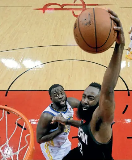  ?? AP ?? Houston Rockets guard James Harden scores despite the attention of Golden State
Warriors forward Kevon Looney.