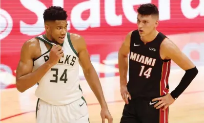  ??  ?? Giannis Antetokoun­mpo, left, and the Milwaukee Bucks made a record 29 three-pointers in their 144-97 win over the Miami Heat on Tuesday. Photograph: Michael Reaves/Getty Images