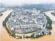  ?? AFP ?? An aerial photograph taken on Monday shows the extent of the flood in Wuyuan city, Jiangxi province.