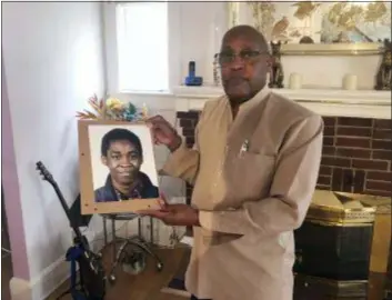  ?? MICHAEL KUNZELMAN — THE ASSOCIATED PRESS ?? In this photo, Dia Khafra, father of Askia Khafra, stands in his Silver Springs, Md., home. Askia Khafra who died last year when a fire broke out at the Bethesda, Md., home where he and a millionair­e day trader were digging tunnels for a nuclear bunker.