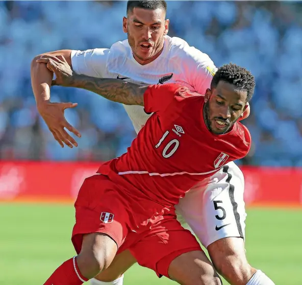  ??  ?? Peru’s Christian Cueva battles for the ball under pressure from New Zealand’s Michael Boxall in Wellington yesterday.
