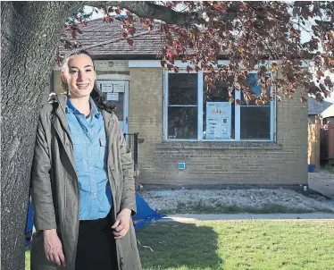  ?? RENÉ JOHNSTON TORONTO STAR ?? Elisa Traficante, director of community initiative­s for Raising the Roof, visits the home, which is under renovation.