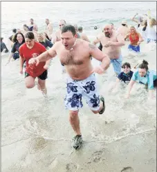  ?? Hearst Connecticu­t Media file photo ?? Runners emerge from the water in the 20th Madison Penguin Plunge.