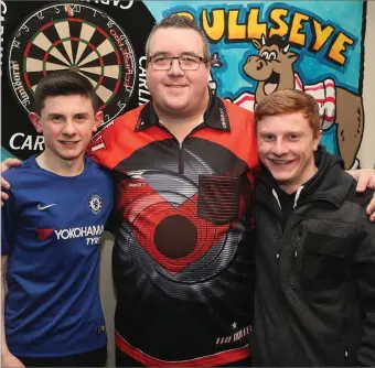  ??  ?? Pro darts player Steve Bunting with Sean and Ciaran Brown during his visit to Nolan’s last week.