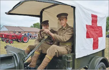  ?? COLIN CHISHOLM ?? Geoffrey Myette (left) and Matt Buckboroug­h, from the Halifax Citadel Regimental Associatio­n, show off a Ford Model T ambulance in period clothing during the antique tractor show.