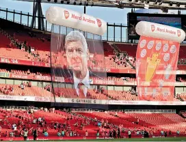  ?? — AP ?? A large photograph of Wenger was suspended from the roof after his final match.