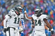  ?? THE ASSOCIATED PRESS ?? The Eagles’ Jordan Howard, right, celebrates his touchdown with Carson Wentz during the second half of Sunday’s game against the Bills.