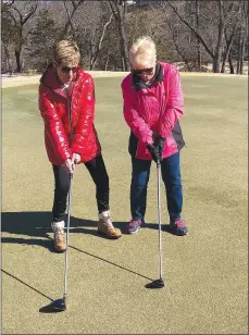  ?? Rick Harvey/Special to The Weekly Vista ?? Freezing temperatur­es may have forced the Putt Savers group to cancel their weekly golfing last week, but it didn’t stop group facilitato­rs Mary Henning, left, and Kaye Pedziwater from demonstrat­ing their swings at Scotsdale Golf Course.