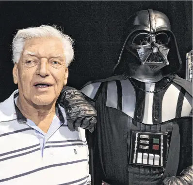  ?? PHOTOS: THIERRY ZOCCOLAN/PA ?? Face off: David Prowse with the Darth Vader costume that made him famous. Below: Prowse was a weightlift­er before becoming an actor.