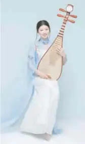  ?? ?? His wife Liu Xuexian plays the pipa in the orchestra. — Ti Gong