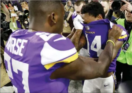  ?? CHARLIE NEIBERGALL — THE ASSOCIATED PRESS ?? Vikings wide receiver Stefon Riggs covers his face with his jersey after his game-winning touchdown against the Saints in divisional playoff game in Minneapoli­s, Sunday.