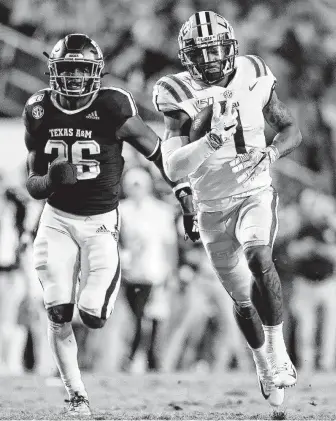  ?? Gerald Herbert / Associated Press ?? LSU’s Ja’Marr Chase runs away from Texas A&M’s Demani Richardson on a 78-yard touchdown reception in the first quarter. The Tigers scored TDs on each of their first four drives.