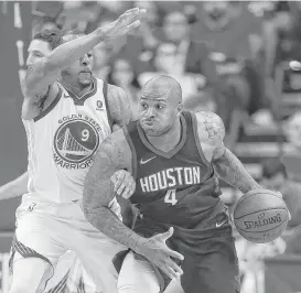  ?? Michael Ciaglo / Houston Chronicle ?? Rockets forward PJ Tucker (4) had a a big game against Andre Iguodala and the Warriors on Wednesday night, amassing 22 points and seven rebounds.