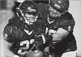  ?? BRIAN O'MAHONEY/FOR THE CHICAGO TRIBUNE ?? Joliet Catholic’s Keenan Hailey (27) celebrates with Conor Kovas after scoring a TD.