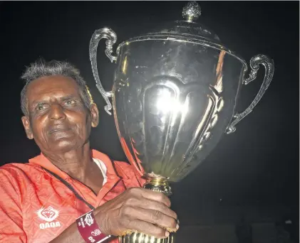  ?? Photo: Fiji FA Media ?? A loyal Labasa football fan Bissun Deo holds the Punjas Battle of the Giants Trophy after their 1-0 win over Lautoka in last year’s final.