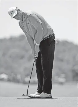  ?? [AP PHOTO] ?? Marc Leishman watches his putt on the ninth green during the second round of the AT&T Byron Nelson Tournament on Friday in Dallas.