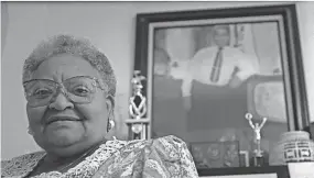  ?? BETH A. KEISER/ASSOCIATED PRESS ?? Mamie Till Mobley stands before a portrait of her slain son, Emmett Till, in her Chicago home on July 28, 1995.