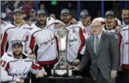  ?? CHRIS O’MEARA — THE ASSOCIATED PRESS ?? NHL Deputy Commission­er Bill Daly, right, poses with members of the Washington Capitals and the Prince of Wales trophy after the Capitals defeated the Tampa Bay Lightning 4-0 during Game 7 of the NHL Eastern Conference finals hockey playoff series...
