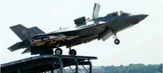  ??  ?? An F-35B developmen­t aircraft carries out ski-jump testing with external stores, as required by the UK customer (photo: Arnel Parker)