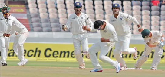  ?? — P. SURENDRA ?? Indian players celebrate the dismissal of Australian captain Michael Clarke on the fourth day of the second Test at the Rajiv Gandhi Internatio­nal Cricket Stadium in Hyderabad on Tuesday. India won by an innings and 135 runs.
