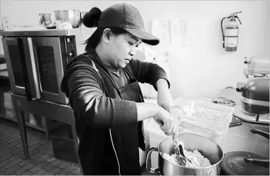  ?? CHRIS DONOVAN THE CANADIAN PRESS ?? A baker at Dlish Cupcakes, a bakery that uses vanilla every day, prepares the day's first batch in
Toronto on Saturday.