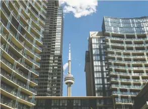  ?? ERNEST DOROSZUK / POSTMEDIA NEWS FILES ?? Condo buildings frame the CN Tower in Toronto. As the attraction­s and need to live
downtown evaporate in the pandemic, the market is shifting to nearby cities.