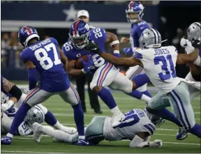  ?? MICHAEL AINSWORTH - THE ASSOCIATED PRESS ?? New York Giants’ Sterling Shepard (87) helps clear running room for running back Saquon Barkley (26) as Dallas Cowboys cornerback Byron Jones (31) defends in the second half of a NFL football game in Arlington, Texas, Sunday, Sept. 8, 2019.