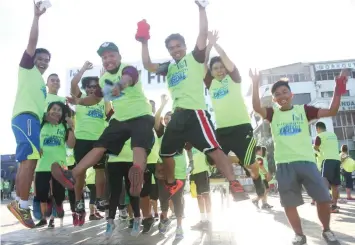  ?? JOY TORREJOS ?? Participan­ts to the "Hope for Butuanon River" Fun Run jump in jubilation after completing the race.