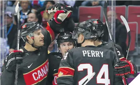  ?? JEAN LEVAC/ POSTMEDIA NEWS ?? HAPPY GANG Ryan Getzlaf, left to right, Matt Duchene, Corey Perry and Shea Weber ( hidden) celebrate Weber’s goal against Austria.