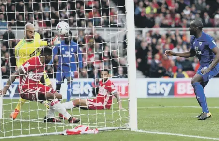  ??  ?? Boro striker Britt Assombalon­ga heads a Sol Bamba header off the line as the Teessiders live dangerousl­y at the Riverside against Cardiff.