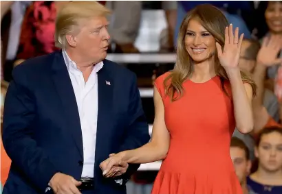  ?? AFP ?? President Trump and Melania Trump stand together during the campaign rally at the AeroMod Internatio­nal hangar at Orlando Melbourne Internatio­nal Airport in Florida. —