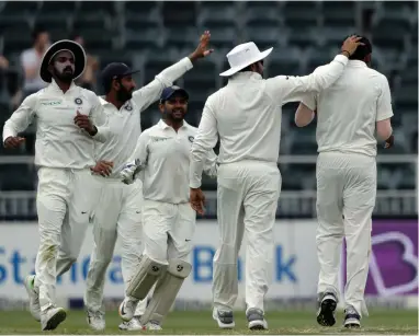  ??  ?? CAREER HIGHLIGHT: Jasprit Bumrah is congratula­ted by teammates after claiming a maiden Test ‘five-for’ at the Wanderers yesterday.