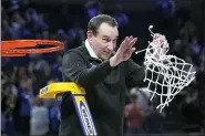  ?? MARCIO JOSE SANCHEZ — THE ASSOCIATED PRESS ?? Duke head coach Mike Krzyzewski celebrates while cutting down the net after Duke defeated Arkansas in a college basketball game in the Elite 8round of the NCAA men’s tournament in San Francisco, Saturday, March 26, 2022.