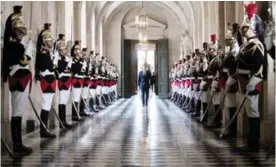  ??  ?? PARIS: French President Emmanuel Macron walks through the Galerie des Bustes (Busts Gallery) to access the Versailles Palace’s hemicycle for a special congress gathering both houses of parliament (National Assembly and Senate) in the Palace of...