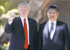  ?? Alex Brandon/Associated Press ?? President Donald Trump and Chinese President Xi Jinping pause for photos Friday at Mar-a-Lago in Palm Beach, Fla.