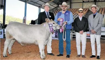  ??  ?? TOP HONOURS: Grand champion square meater steer Oakvale Jesse James with judge Brent Evans, handler David Sewell, presenter Peter Brown and owner Gary Sewell.