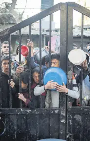  ?? ?? Displaced Palestinia­n children gather to collect food aid, Rafah, Gaza Strip, Palestine, March 11, 2024.