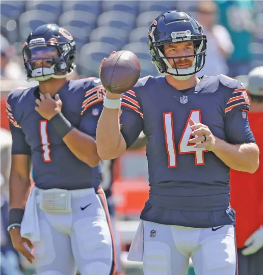  ?? JONATHAN DANIEL/GETTY IMAGES ?? Andy Dalton will start against the Rams on Sunday night, but he certainly can feel rookie Justin Fields looming over his shoulder.