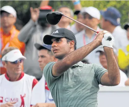  ??  ?? Shubhankar Sharma watches his tee shot during the third round of the CIMB Classic.