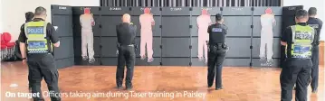  ??  ?? On target Officers taking aim during Taser training in Paisley