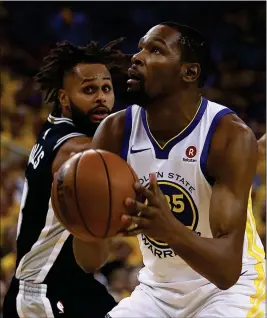  ?? ASSOCIATED PRESS ?? GOLDEN STATE WARRIORS’ KEVIN DURANT (RIGHT) shoots against San Antonio Spurs’ Patty Mills (8) during the first half in Game 1 of a first-round playoff series Saturday in Oakland, Calif.